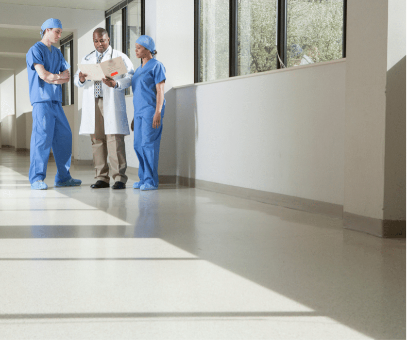 Rural physicians engaged in reviewing data analysis presented by a healthcare consultant.